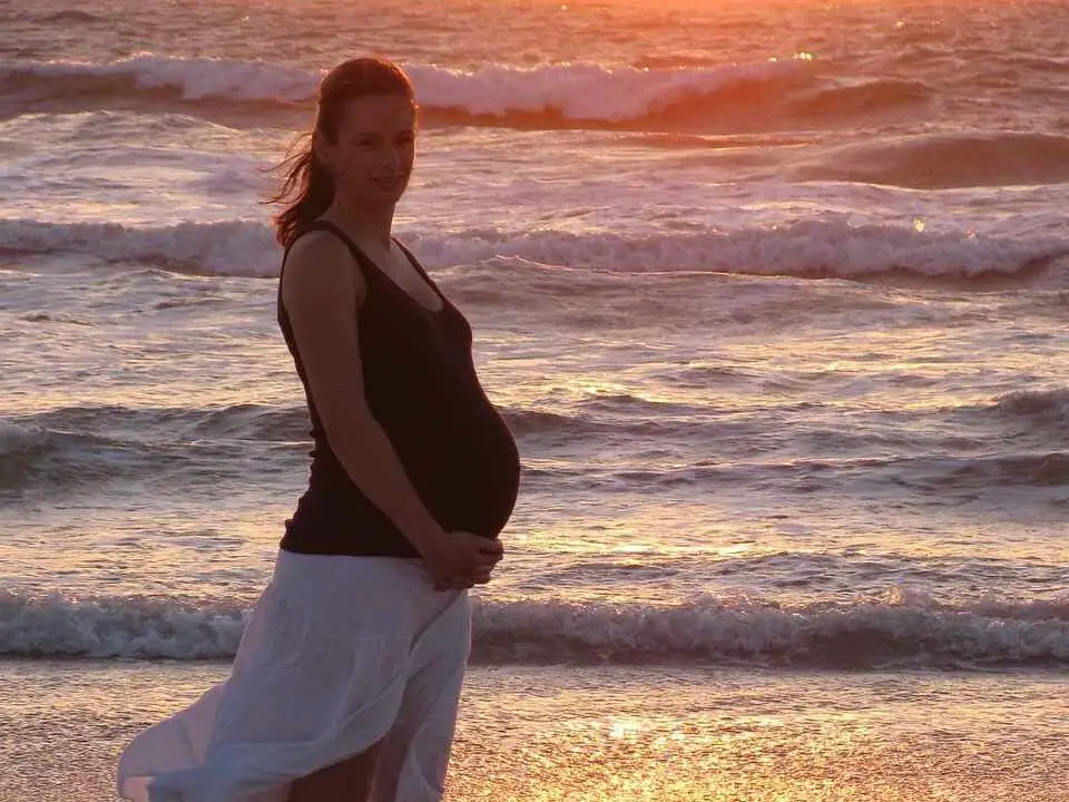Pregnant woman by the beach